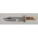 A Bowie Knife with antler scales and brass cross guard by Mortons of Sheffield with work buck