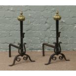 A good pair of wrought iron fire dogs with ornate brass finials.