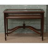 An Edwardian style mahogany bijouterie table raised on square tapering supports.