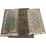 Two Chinese wool rugs with stylized decoration 62 x 120cm and a latte coloured twist wool rug.
