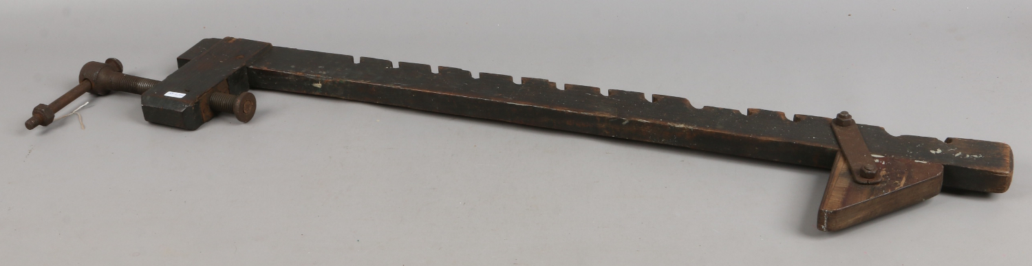 An antique wooden constructed sash cramp.