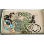 A tray of costume jewellery including bracelets, necklaces, brooches etc.