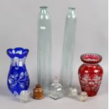 A collection of glasswares to include hand blown cucumber straighteners, coloured cut glass vases,