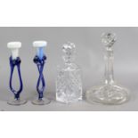 Two cut glass decanters along with two art glass candlesticks.