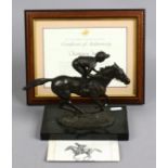 A cast bronze sculpture of a racehorse and jockey by David Cornell 1985.