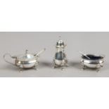A silver cruet set, two with Bristol blue glass liners.