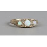 A 9ct gold ring set with three opal and diamonds, size K1/2.