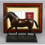 A cast bronze sculpture of a stallion.