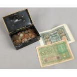 An old money box and contents of coins to include Victorian/Edwardain silver three penny bits etc.