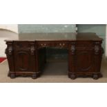 A large carved mahogany partners desk decorated with lion masks,