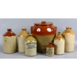 A stone egg preserver and six stoneware flagons including advertising examples including Brynco of