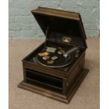 An oak cased Columbia 'granfonola' gramophone complete with sound box winding handle and spare