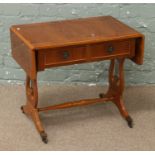 A yew wood two drawer sofa table raised on twin lyre supports.