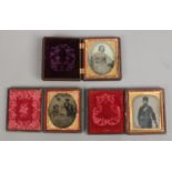 Three Victorian daguerreotypes, two in leather cases and one in a Bakelite case.