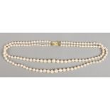A vintage double string of pearls with a 9ct gold clasp.
