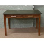 A 1930s oak two drawer desk.