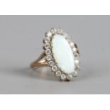 A 9ct gold ring with navette shape opal, halo set with white paste stones, size K1/2.