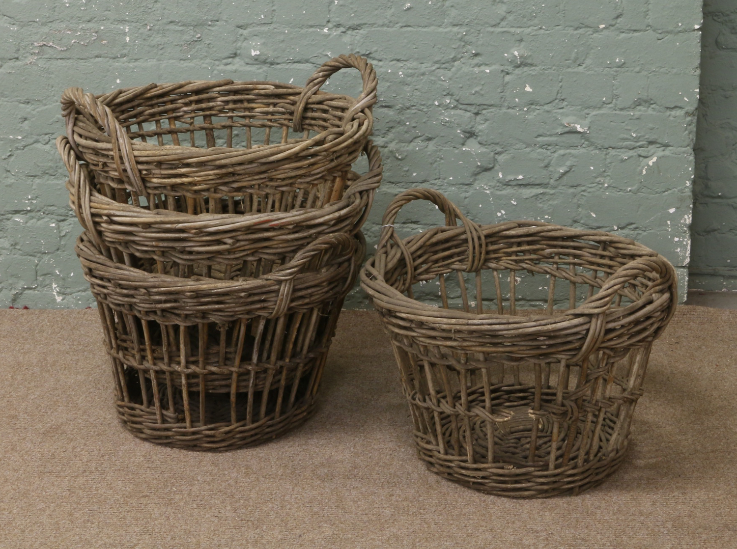 Four twin handle potato picker baskets.
