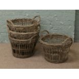 Four twin handle potato picker baskets.