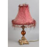 A decorative tablelamp with gilt and amber coloured glass base.