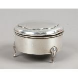 A silver trinket box of circular form raised on reeded cabriole feet, hallmarks indistinct.