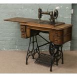 A mahogany cased treadle sewing machine by White USA.