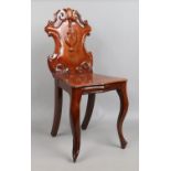 A carved shield back mahogany hall chair.