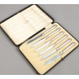 A cased set of six George V silver handled cheese knives by Walker and Hall, assayed Sheffield 1914.
