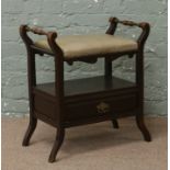 A Victorian piano stool with single drawer and on ratchet adjusting mechanism.