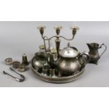 A collection of silver and silver plate items to include napkin rings, sugar tongues, serving trays,