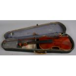 A cased Czechoslovakia violin and bow bearing label Antonius Stradivarius in need of restoration.