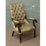 An olive green leather Chesterfield scroll armchair raised on turned supports.