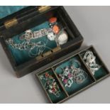 An antique green silk lined jewellery box and contents of silver jewellery including pendants set
