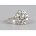 A white metal floriform ring set with diamonds, size P1/2.