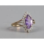 A 9ct gold ring set with marquise cut amethyst and diamonds, size O.