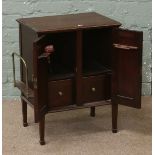 A carved oak Edwardain smokers cabinet raised on spade foot,
