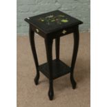 An ebonized plantstand.