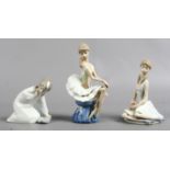 A Lladro porcelain figurine of a young girl, along with two similar examples of ladies.