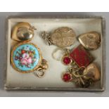 A group of gold plated lockets, along with yellow metal souvenirs, earrings etc.