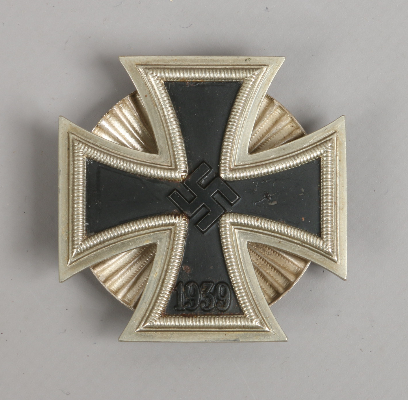 A World War II German Third Reich iron cross merit badge, 1st class with screw back.