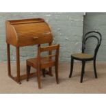 A childs swallow roll top desk (light damage) and chair, along with a childs Bentwood chair.