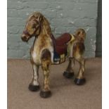 A vintage painted metal "Mobo" toy horse.