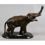 A bronze model of an Indian elephant on wooden plinth.