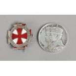 A commemorative silver medal and an enamelled silver nurses badge.