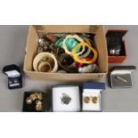 A box of collectables including a china half doll, boxed earrings, shirt buttons, bangles etc.