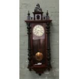 A Victorian Gustav Becker Silesia wall clock with enamel dial Roman numerals and chiming on a gong