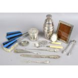 A box of silver and white metal items including a cocktail shaker,