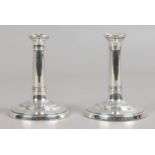 A pair of weighted silver tapersticks assayed Birmingham 1904.