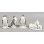 Four Lladro models of animals three penguins and a group of polar bears.