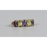 A 9ct gold five stone ring set with peridot and amethyst, size J.